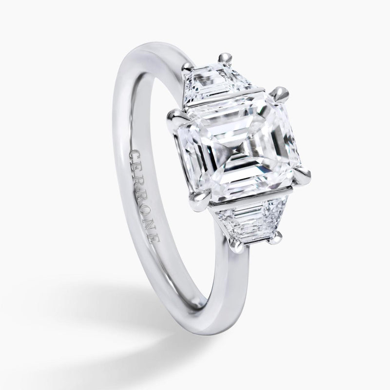 Platinum emerald cut and trapezoid step cut diamond ring