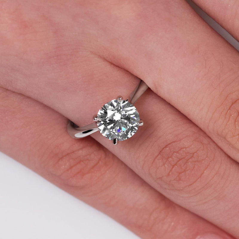 Platinum 2.20ct round brilliant cut diamond four claw solitaire ring on finger