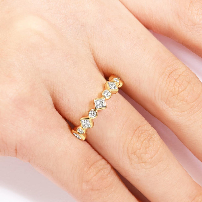 18ct yellow gold full circle round and princess cut diamond ring on the finger