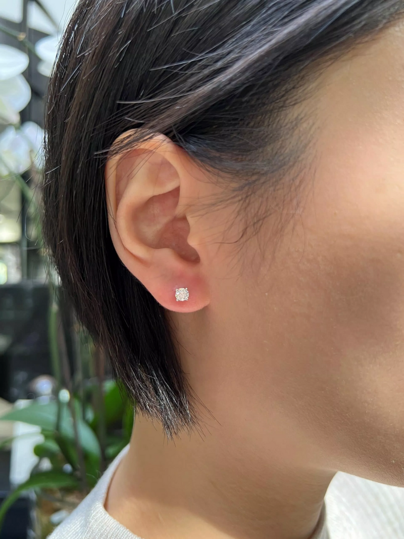 18ct white gold round brilliant cut diamond solitaire stud earrings in a four claw setting on the ear