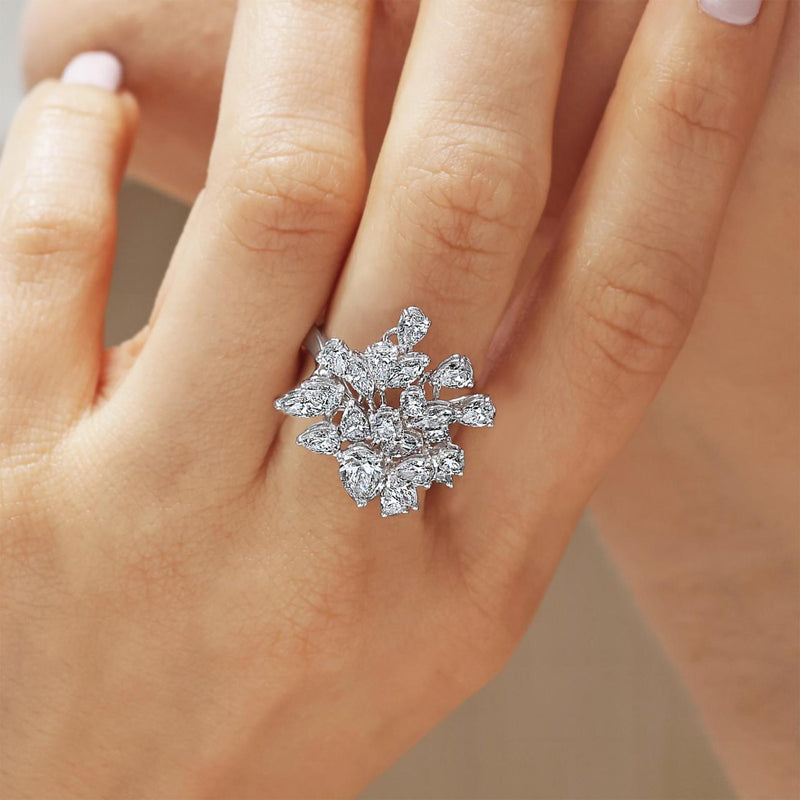 18ct white gold pear, marquise and round brilliant cut diamonds ring on the finger