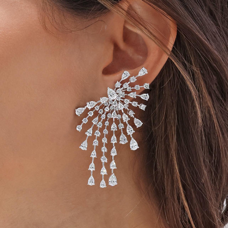 18ct white gold pear and round brilliant cut diamond fancy drop earrings on the ear