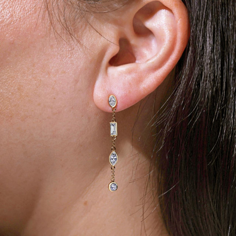 18ct yellow gold baguette, oval and round LAB Grown Diamond bezel set drop earrings on the ear