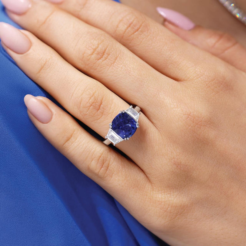 18ct white gold cushion cut Ceylon sapphire and trapezoid step cut diamond ring on the finger