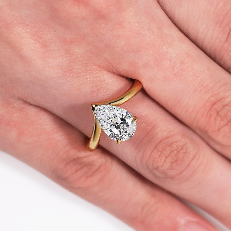 18ct yellow gold pear shaped LAB Grown Diamond solitaire ring on finger