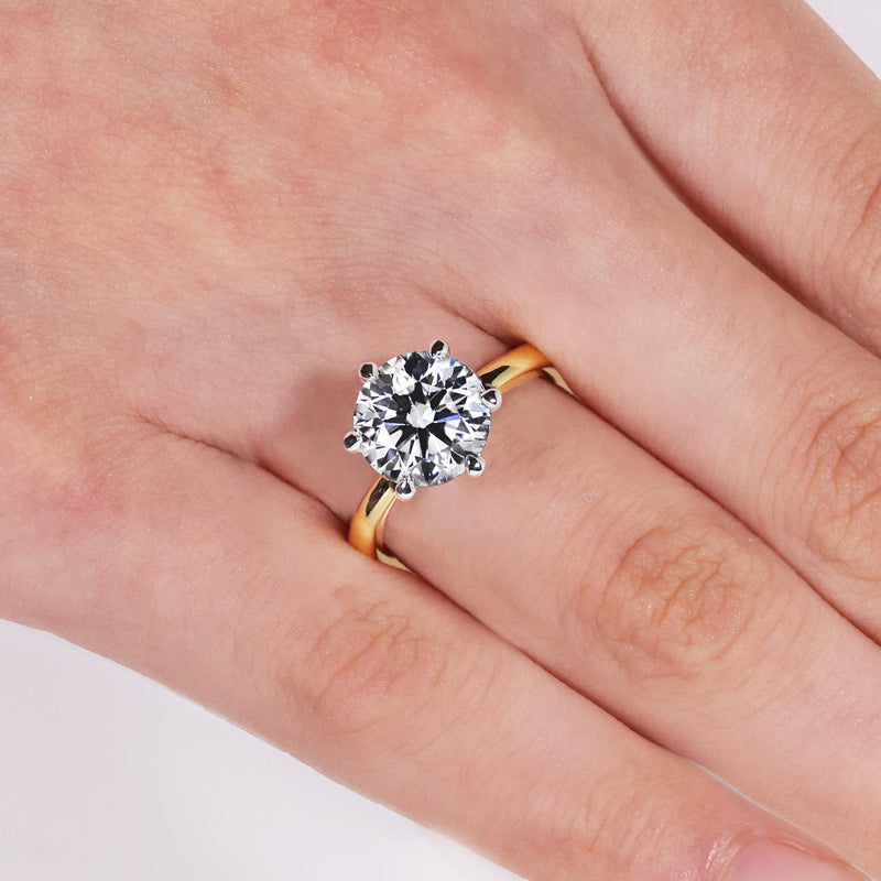 18ct yellow and white gold 3.20ct round brilliant cut lab grown diamond six claw solitaire ring on finger