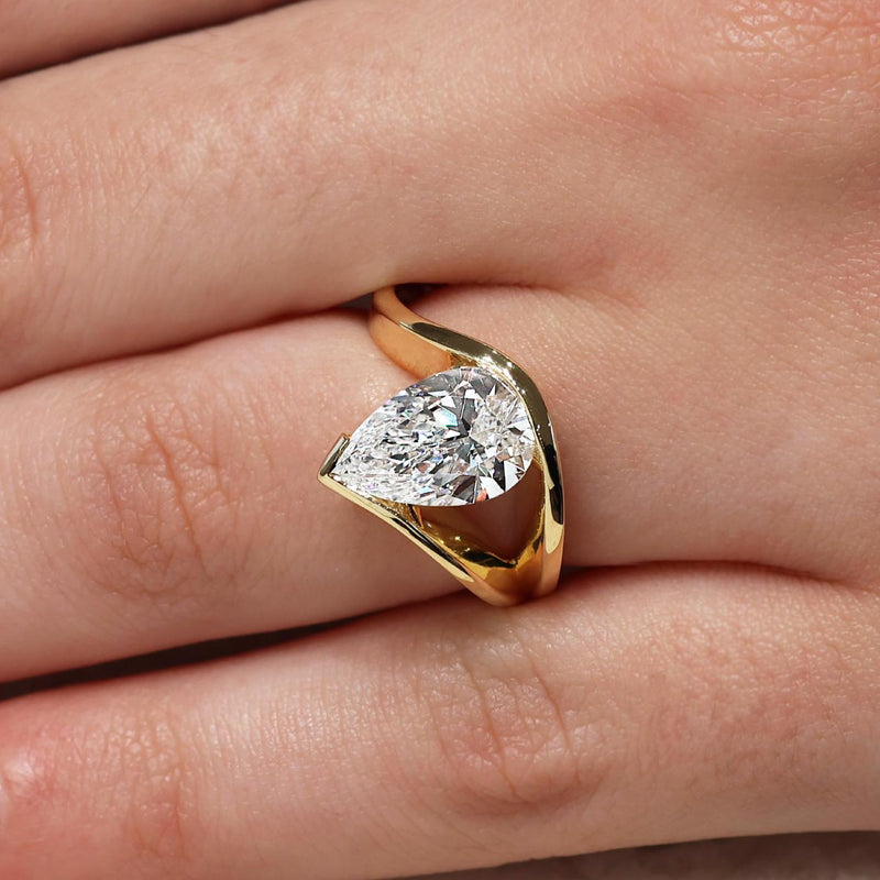18ct yellow gold pear shaped LAB GROWN Diamond solitaire ring on finger
