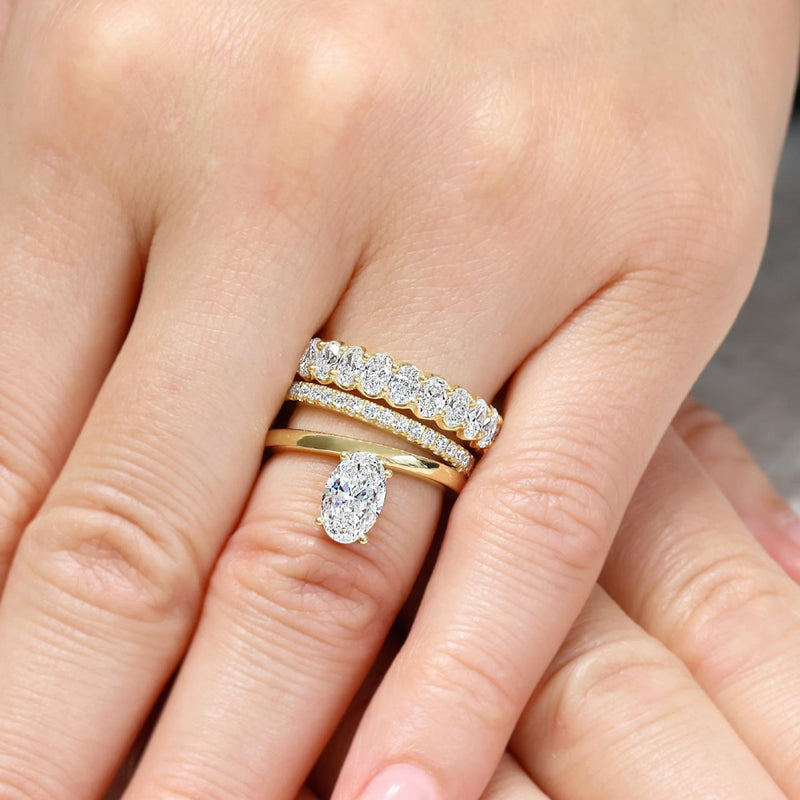 18ct yellow gold 1.20ct oval brilliant cut diamond engagement ring on finger
