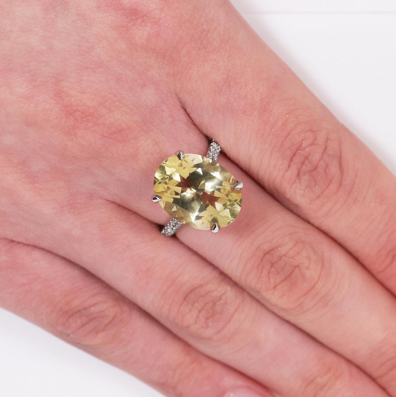 18ct white gold oval lemon quartz and diamond ring on the finger