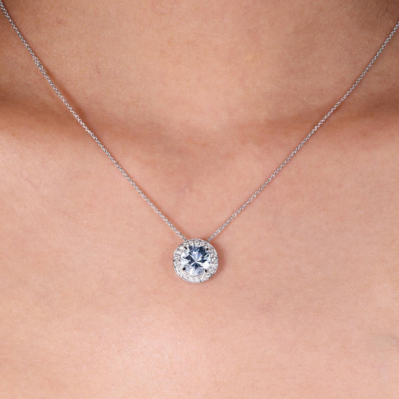 18ct white gold round Santa Maria aquamarine and diamond claw set necklace on the neck