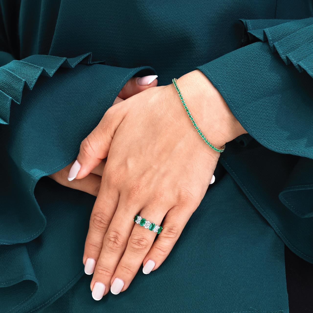 18ct white gold emerald and diamond claw set ring on the finger