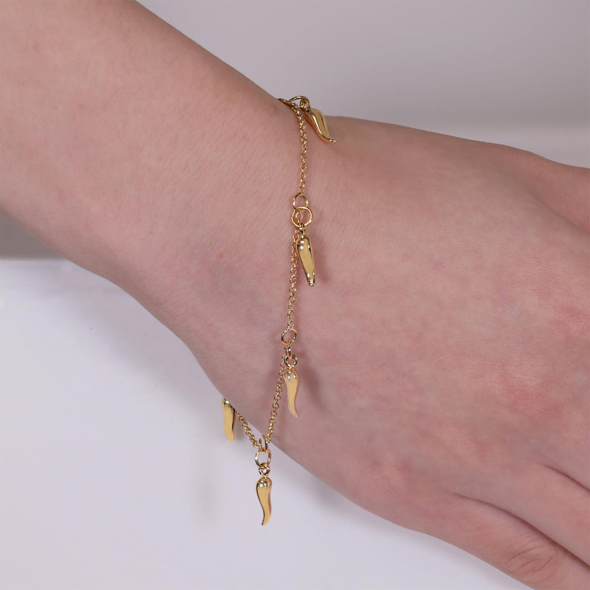 18ct yellow gold corno charms belcher bracelet on the wrist