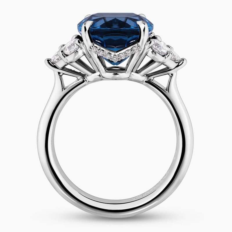 18ct white gold 6.09ct oval shape London blue topaz and diamond ring with pear, princess and round brilliant cut diamonds side profile