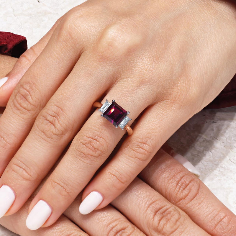18ct white and rose gold carre cut rhodolite garnet and baguette diamond ring on the finger