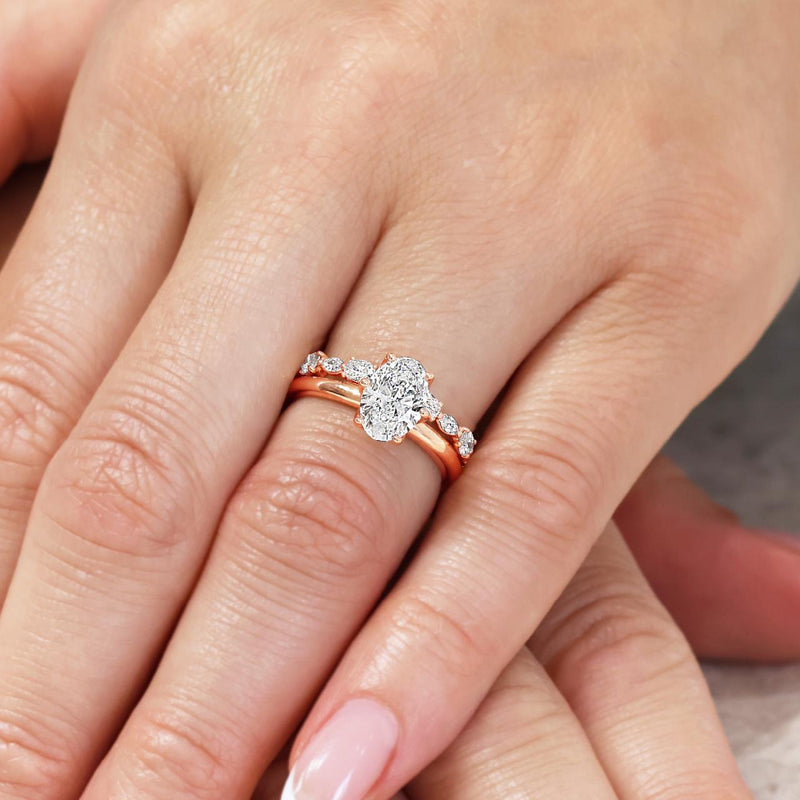 18ct rose gold marquise and oval cut diamond ring on the finger
