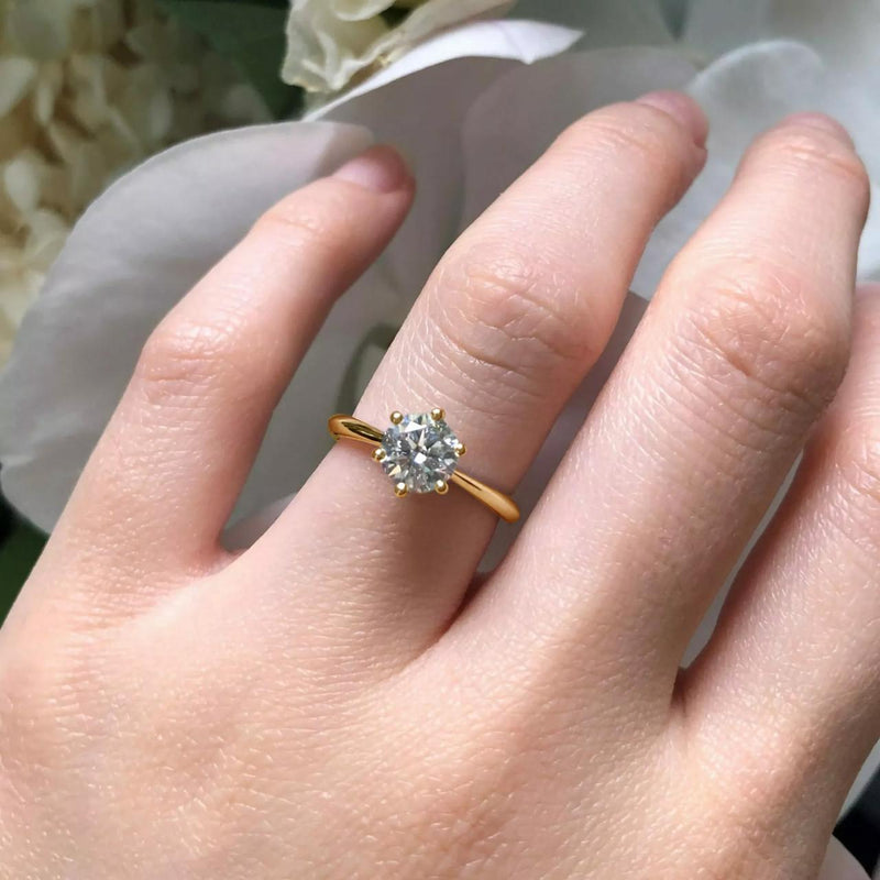 18ct yellow gold 1.01ct round brilliant cut lab grown diamond ring in six claw setting on finger