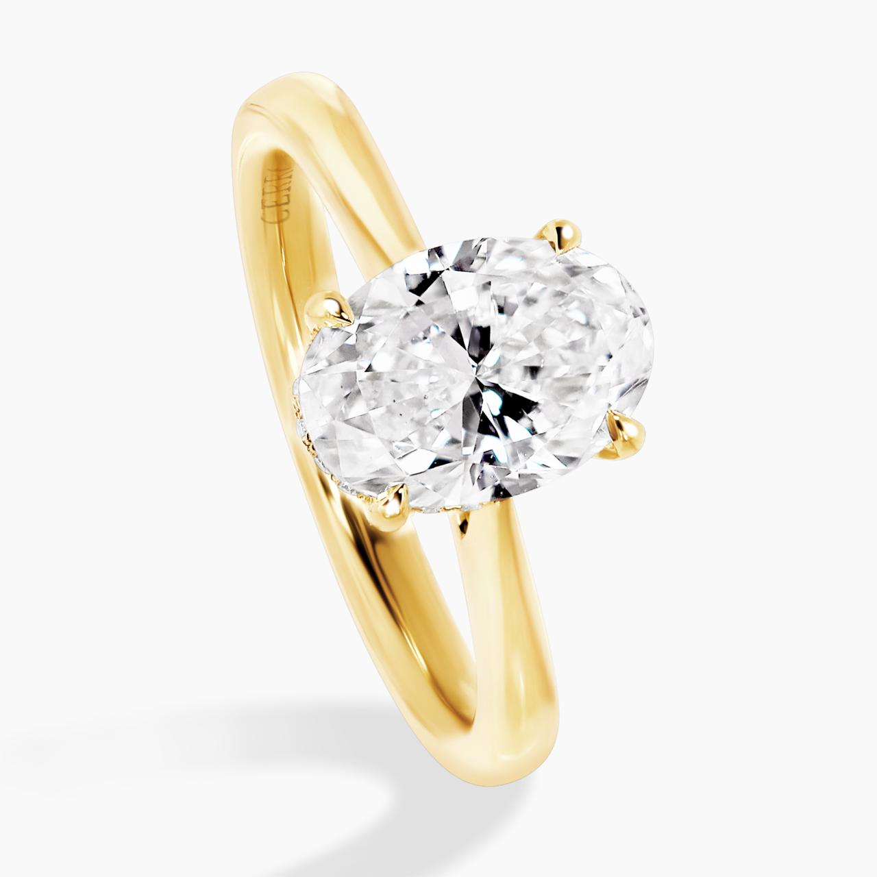 18ct yellow gold oval diamond ring in a four claw setting with hidden halo side angle