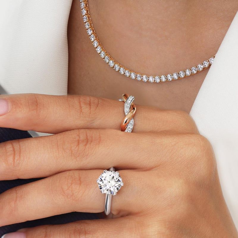 18ct yellow gold round brilliant cut diamond tennis necklace displayed on the neck