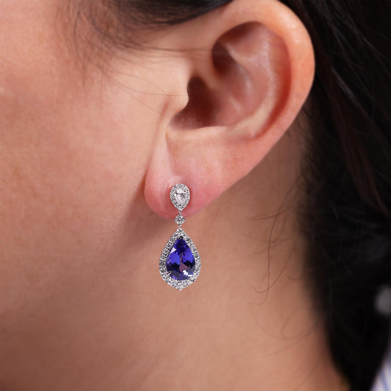 18ct white gold pear shape tanzanite and diamond drop earrings on the ear