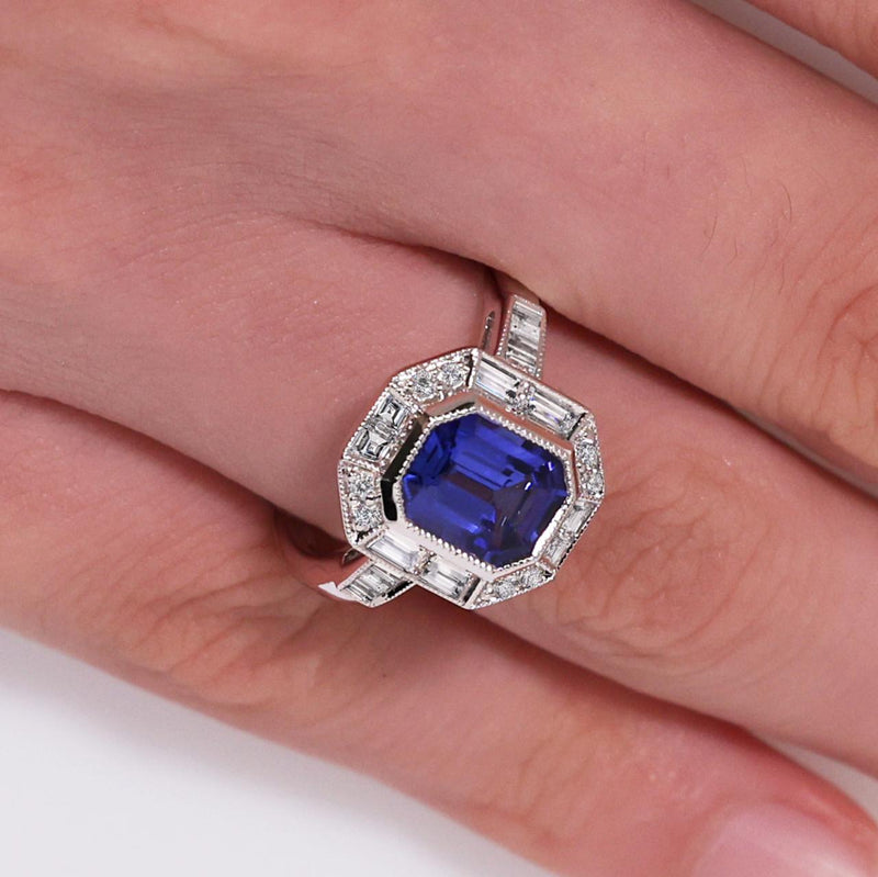 18ct white gold emerald cut tanzanite and diamond ring on the finger