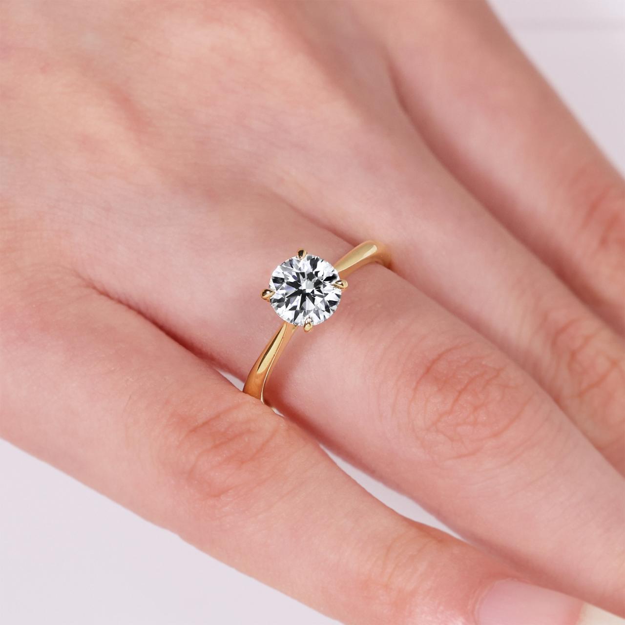 18ct yellow gold 1.20ct F SI1 round brilliant cut diamond four claw solitaire ring