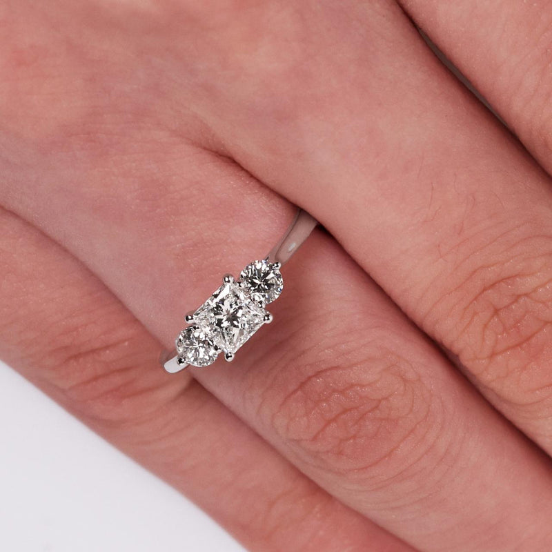 18ct white gold 0.54ct princess cut and round brilliant cut diamonds three stone ring on finger