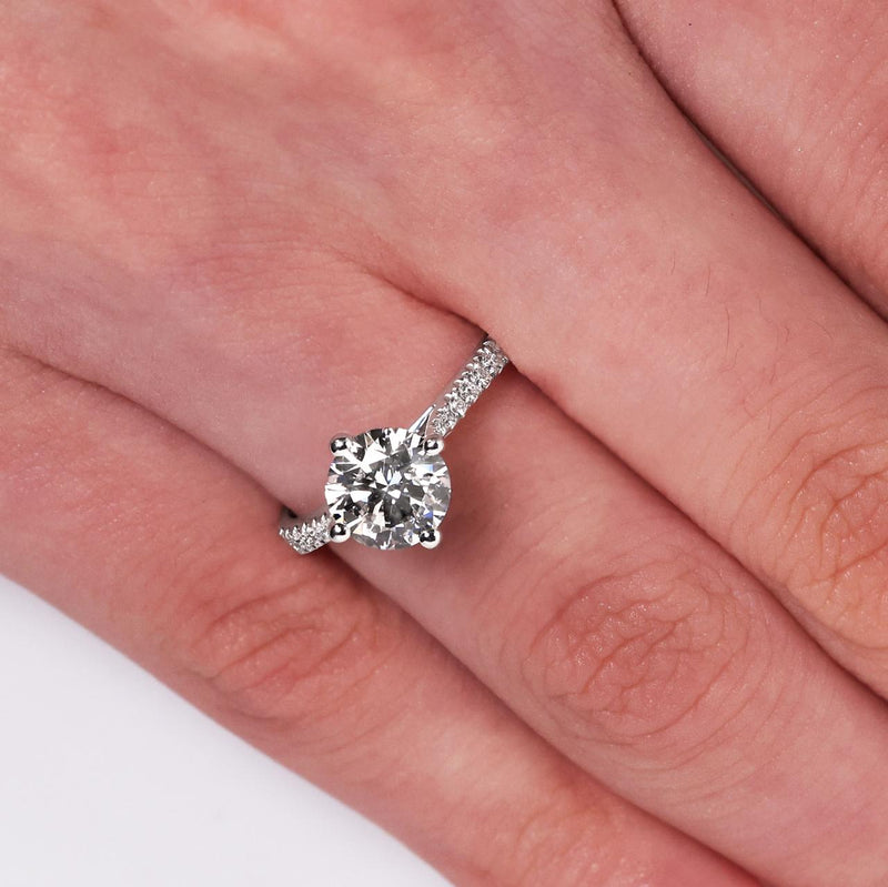 18ct white gold round brilliant cut diamond ring with diamond band on finger