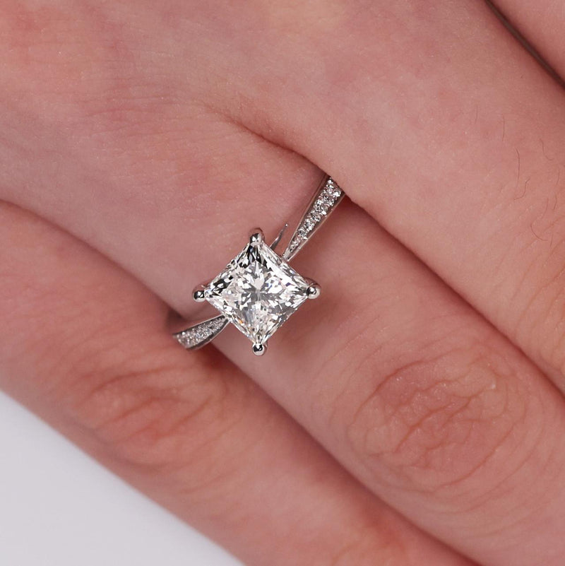 18ct white gold princess and round brilliant cut diamond ring on finger