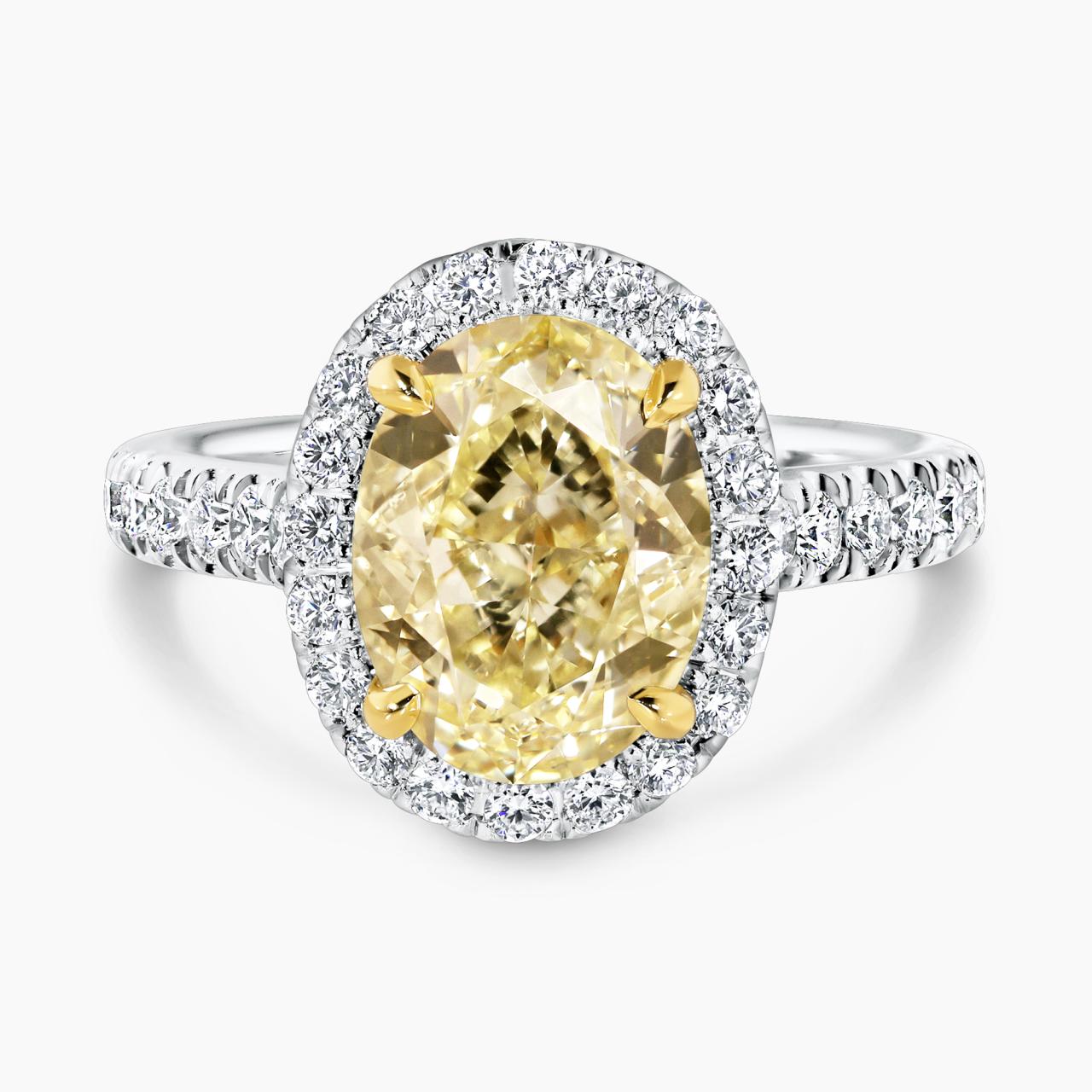18ct white and yellow gold 3.50ct fancy yellow oval cut and white diamond halo ring