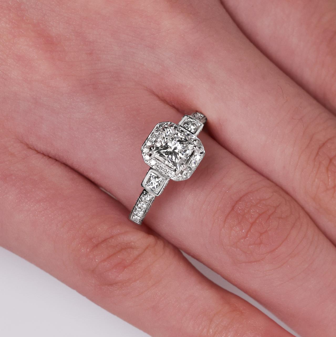 18ct white gold 1.00ct and 2=0.14ct princess cut diamond bezel set halo three stone ring