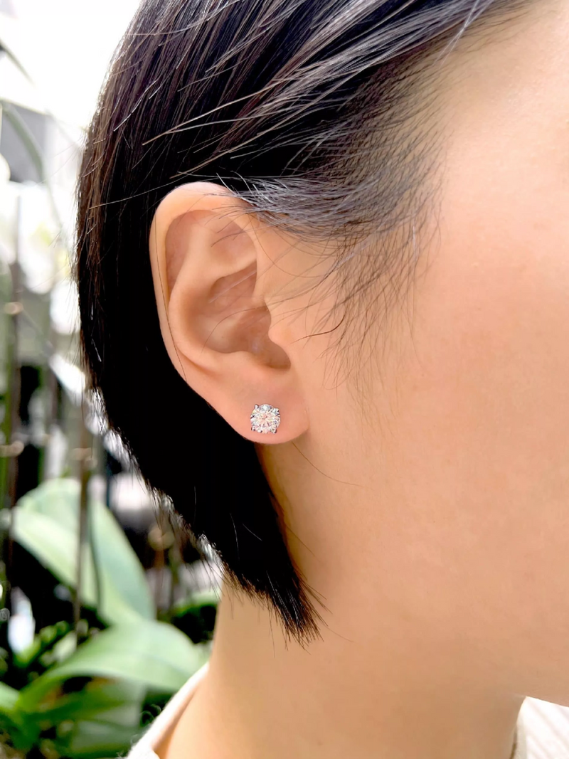 18ct white gold round brilliant cut LAB Grown Diamond solitaire stud earrings in a four claw setting on the ear