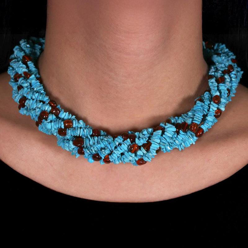 Turquoise and Amber 8 rows beads necklace ended with a silver magnetic clasp from the Carmela Cerrone Collection on the neck