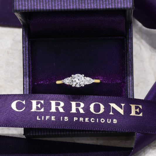 18ct yellow and white gold round brilliant cut and pear shaped diamond engagement ring 