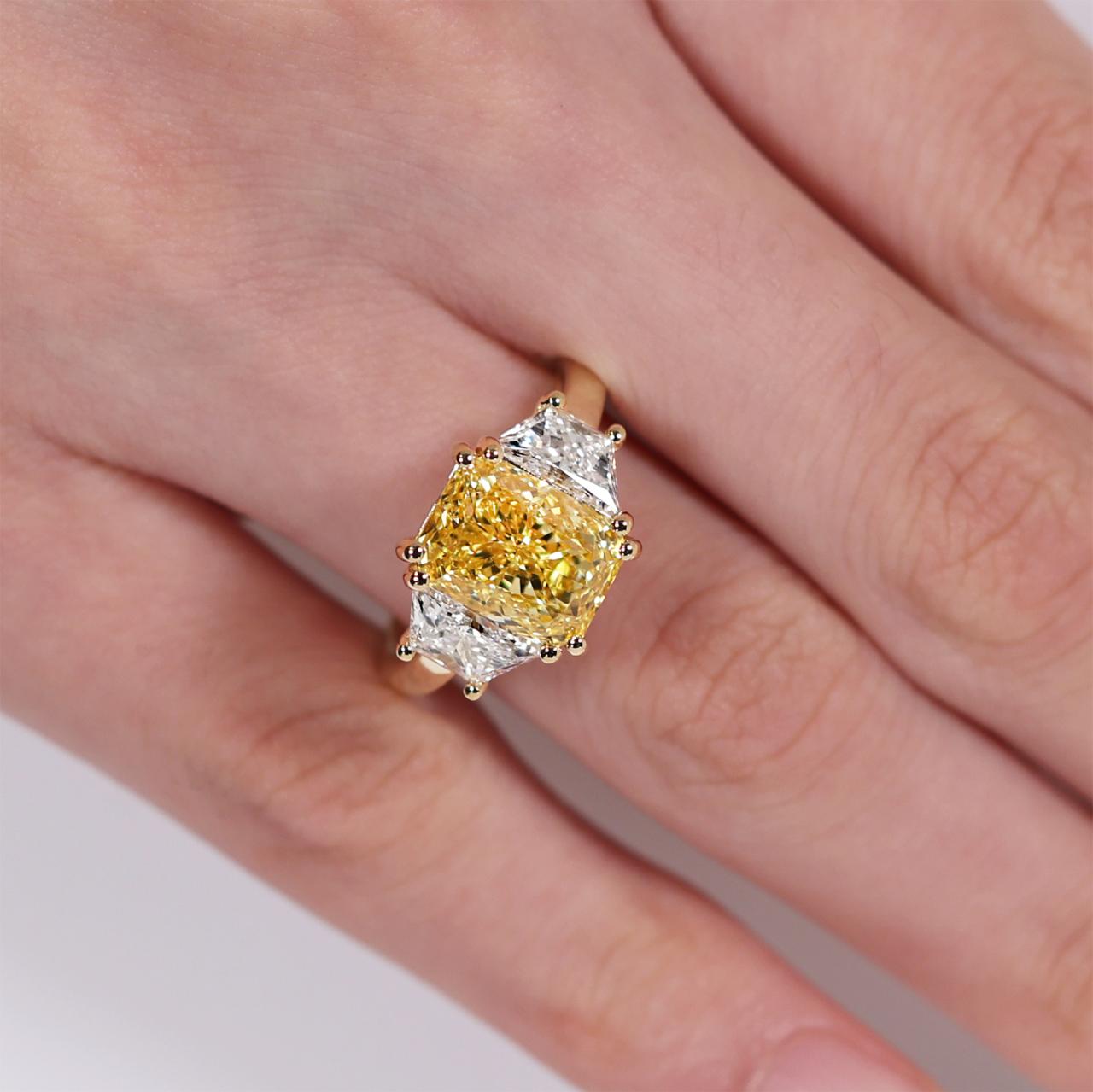 18ct yellow gold radiant LAB Grown diamond engagement ring with trapezoid Lab Grown diamonds on the finger