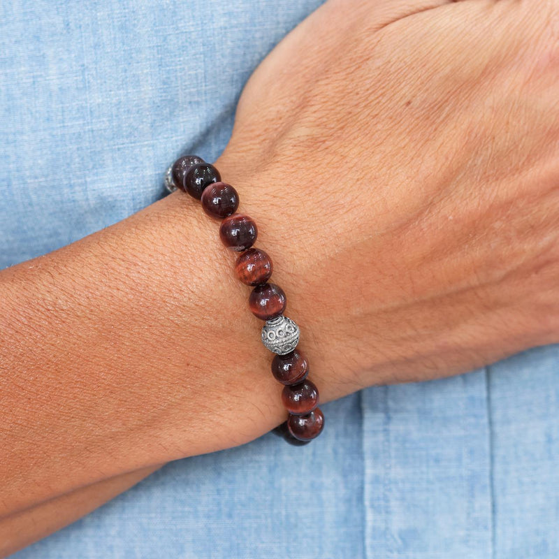 Red tiger eye and silver bead stretch bracelet on the wrist