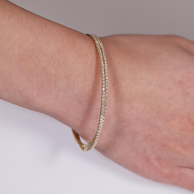 18ct yellow and white gold double layered diamond claw set bangle on the wrist