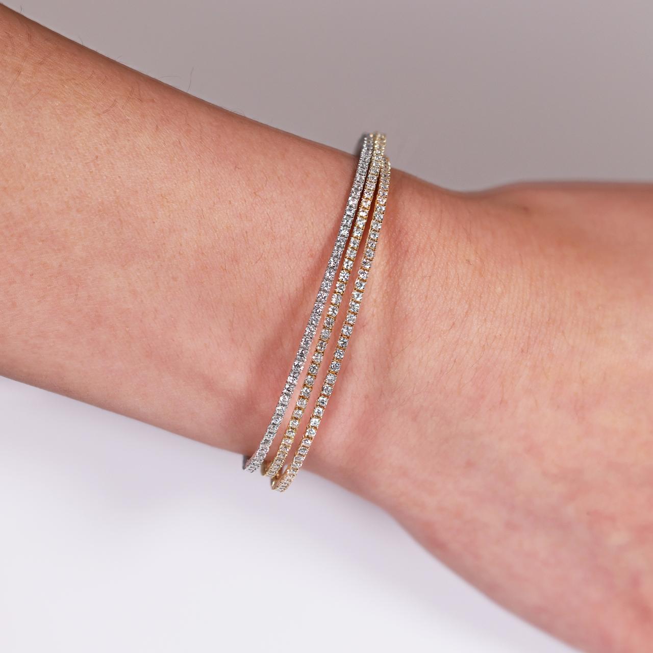 18ct rose, yellow and white gold three layered diamond claw set bangle on the wrist