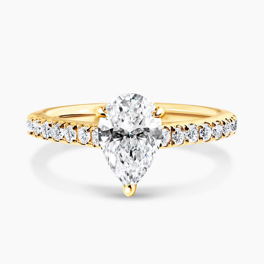 COMO - 18ct yellow gold pear shaped diamond engagement ring in a three claw setting with diamonds on the band