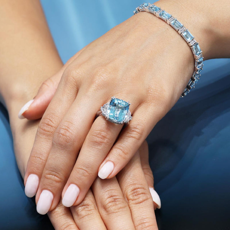 18ct white gold cushion cut aquamarine and diamond ring on the finger