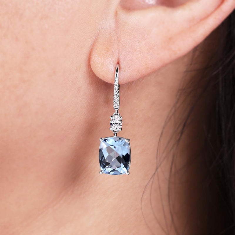 18ct white gold cushion cut aquamarine and diamond drop earrings on the ear
