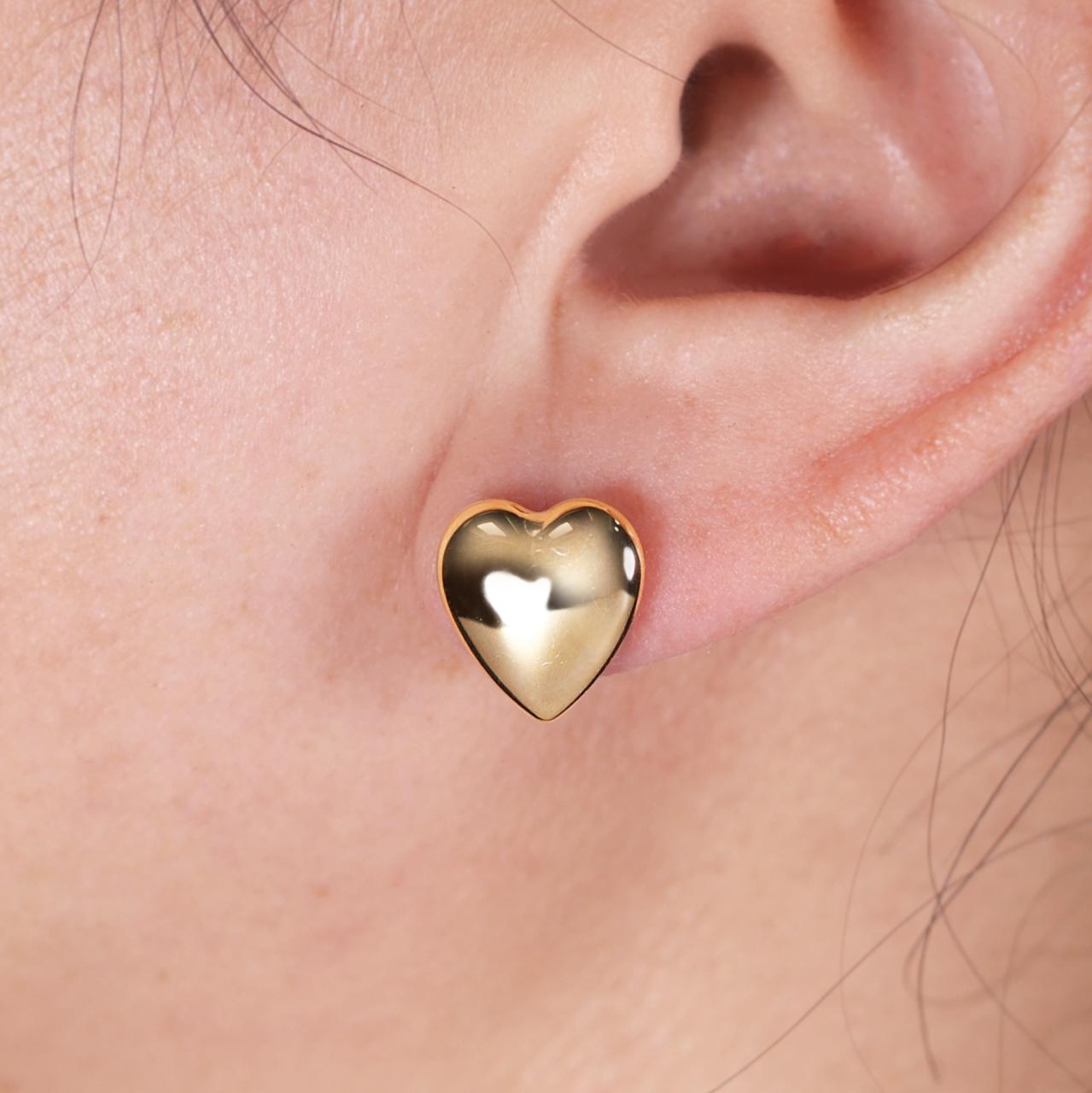 18ct yellow gold heart stud earrings on the ear