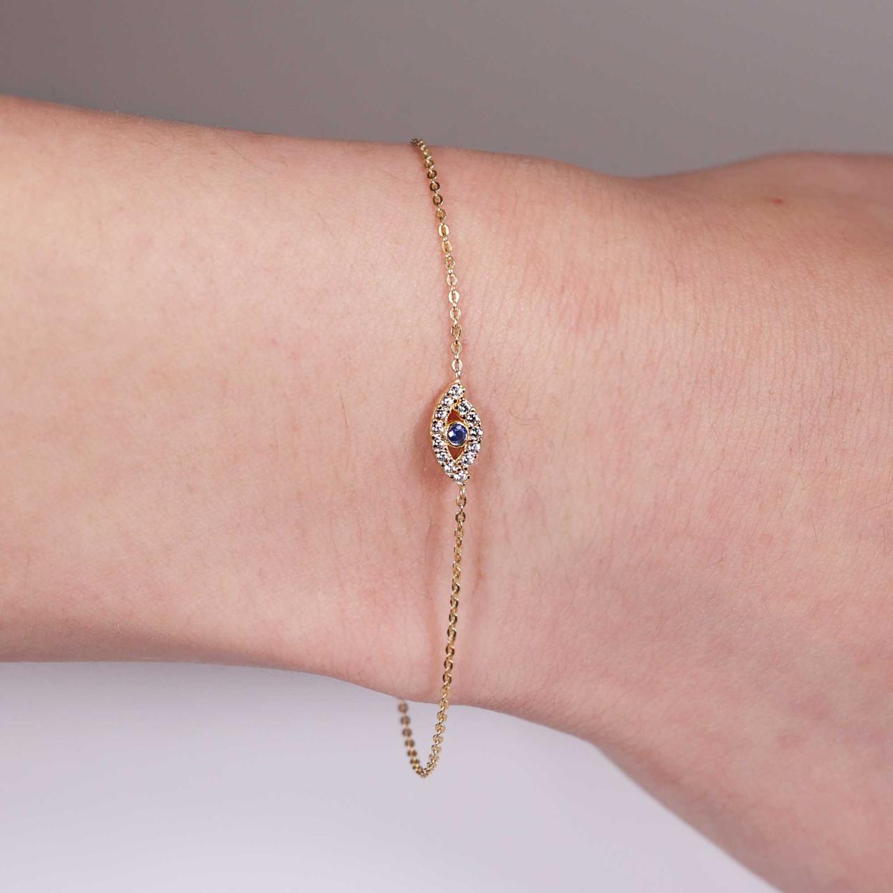 18ct yellow gold cubic zirconia set evil eye bracelet on the wrist