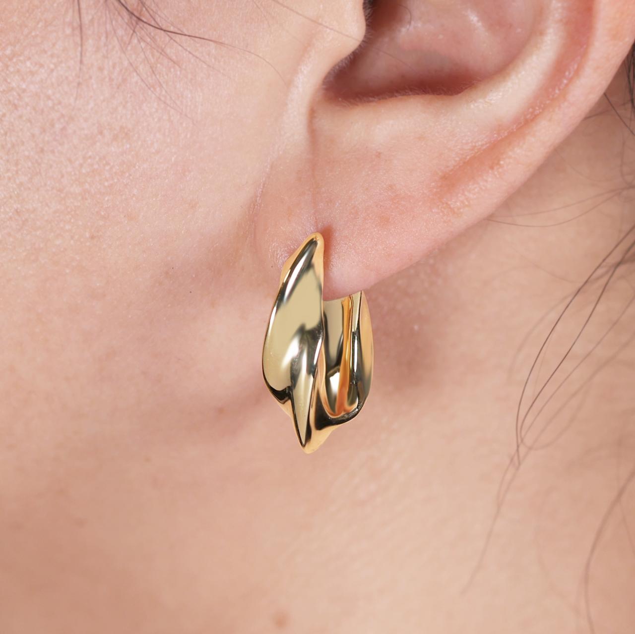 18ct yellow gold hollow chunky oval hoop earrings on the ear