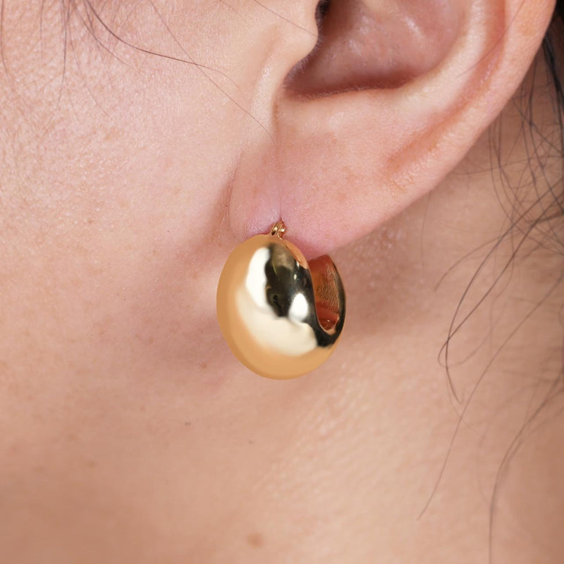 18ct yellow gold hollow chunky hoop earrings on the ear