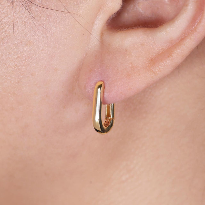 18ct yellow gold rectangular huggies on the ear