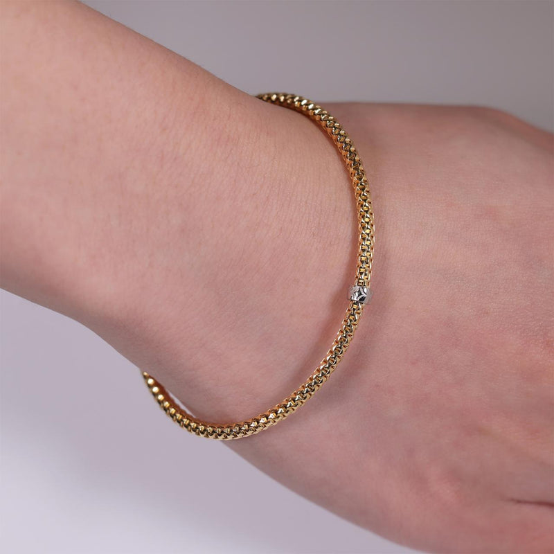 18ct yellow gold stretch mesh bracelet with an 18ct white gold rondel on the wrist