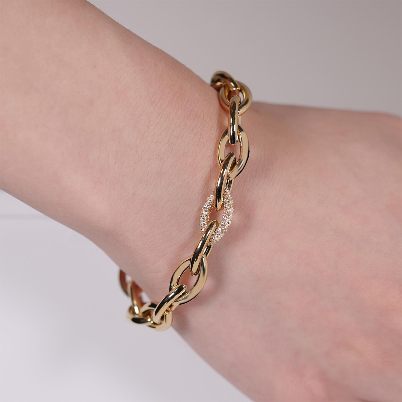 18ct yellow gold diamond set oval link chain bracelet with lobster clasp on the wrist