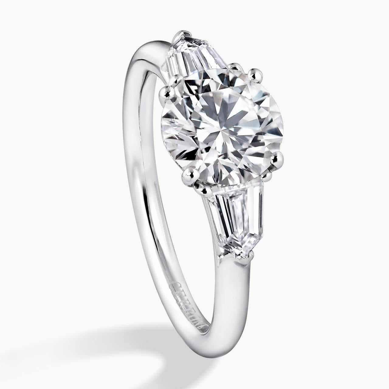Platinum 1.50ct round brilliant cut diamond ring featuring 2=0.59ct bullet diamonds in a claw setting