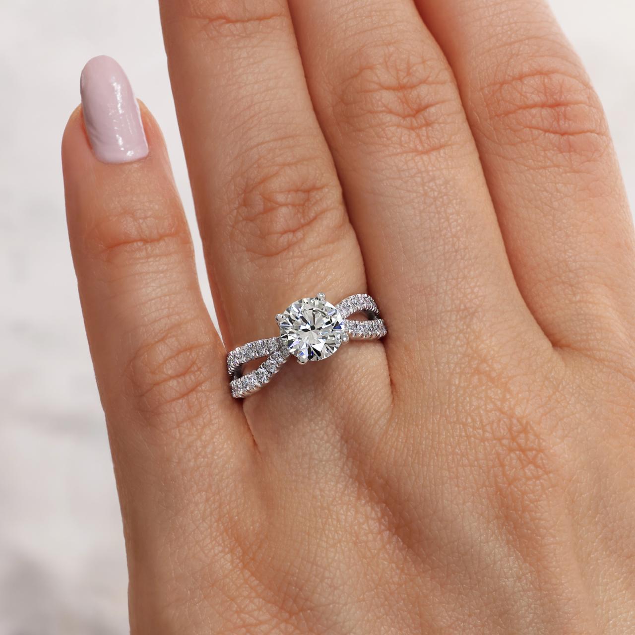 18ct white gold round brilliant cut diamond ring featuring round fancy pink diamonds on finger