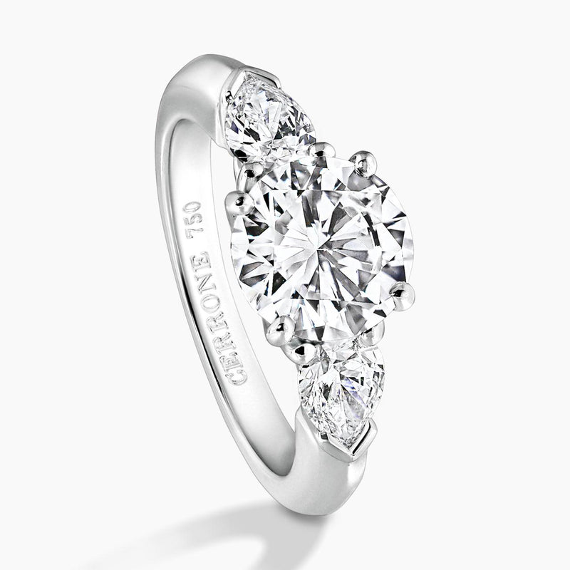 18ct white gold round brilliant cut diamond ring with pear shaped diamonds on the sides side view